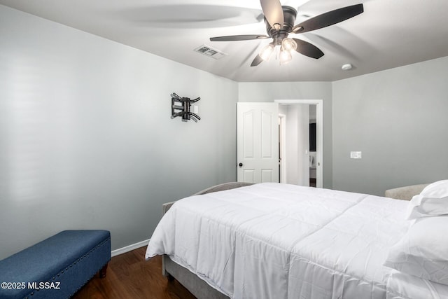 bedroom featuring visible vents, ceiling fan, baseboards, and wood finished floors