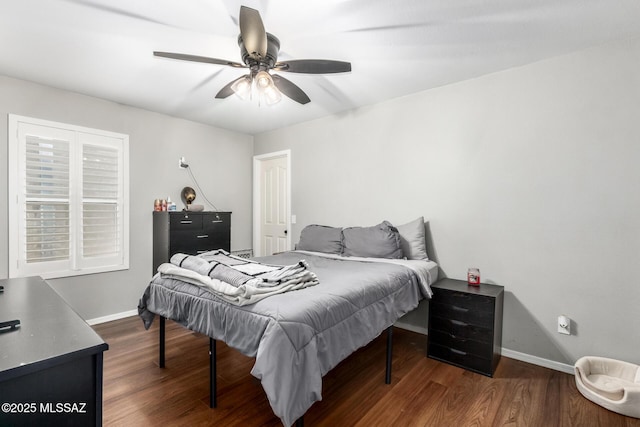 bedroom featuring ceiling fan, baseboards, and wood finished floors