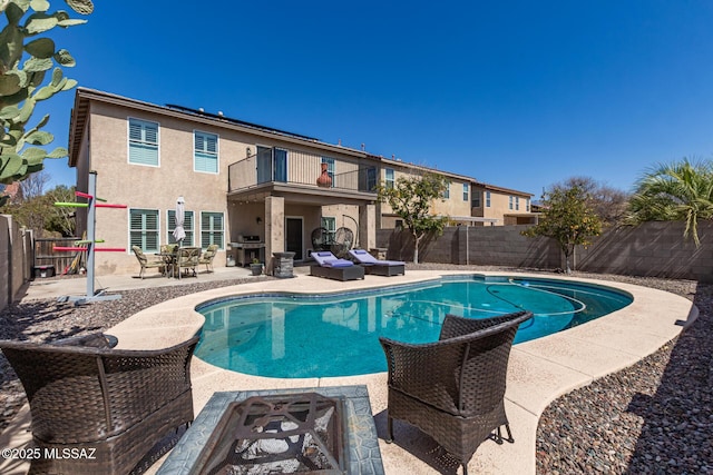 view of pool with a fenced in pool, a fenced backyard, and a patio area