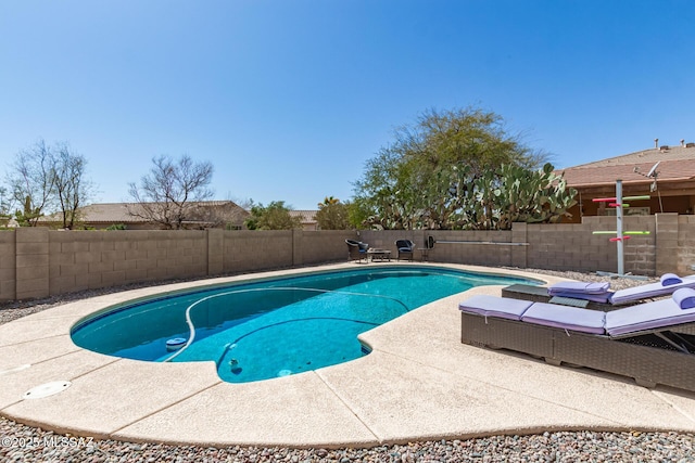 view of swimming pool with a patio area, a fenced in pool, and a fenced backyard