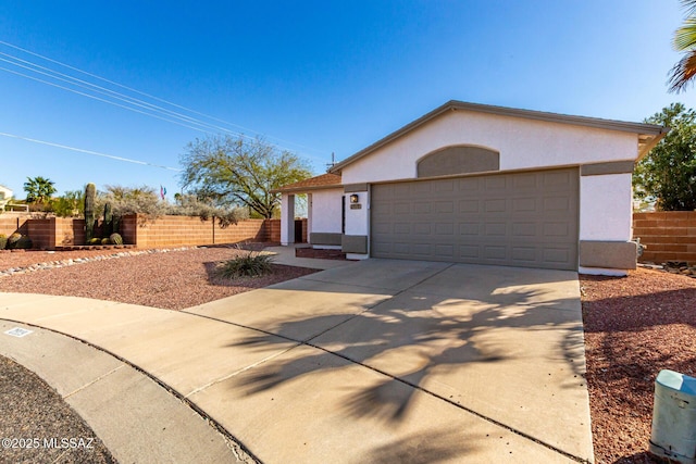 ranch-style house featuring fence, a garage, driveway, and stucco siding