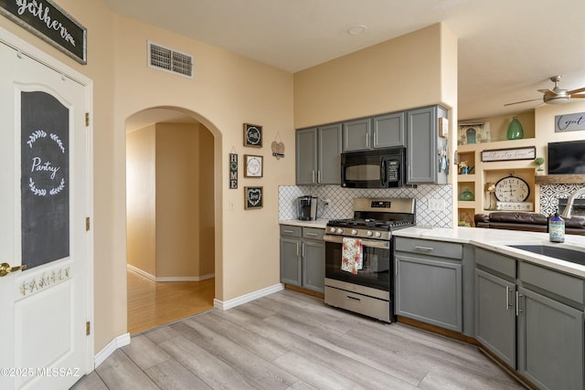 11219 N Platte Dr, Oro Valley, AZ 85737 - kitchen featuring stainless steel range with gas stovetop, gray cabinets, black microwave, and a sink
