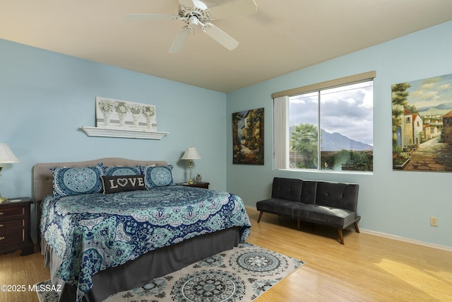 11219 N Platte Dr, Oro Valley, AZ 85737 - bedroom featuring a ceiling fan, wood finished floors, and baseboards