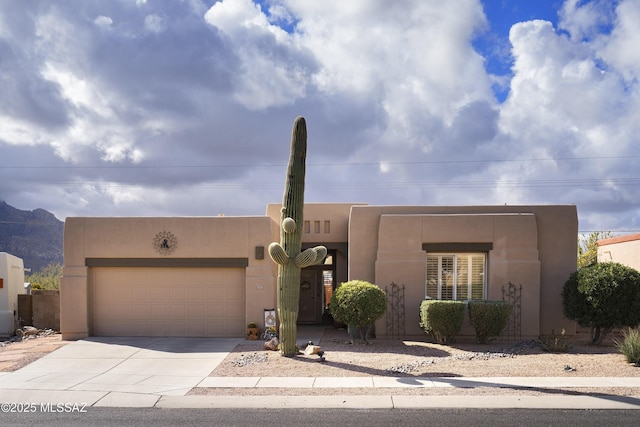 11219 N Platte Dr, Oro Valley, AZ 85737 - adobe home featuring a garage, concrete driveway, and stucco siding