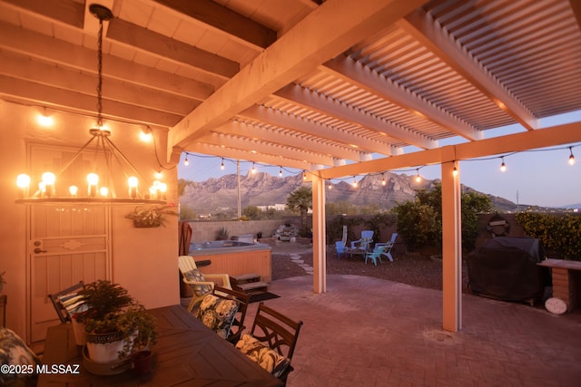 11219 N Platte Dr, Oro Valley, AZ 85737 - view of patio with a hot tub, a mountain view, a fenced backyard, a grill, and a pergola