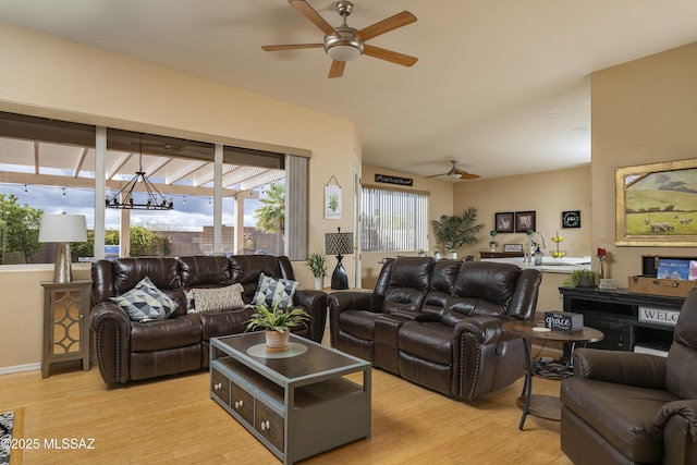 11219 N Platte Dr, Oro Valley, AZ 85737 - living room featuring ceiling fan with notable chandelier and light wood-type flooring