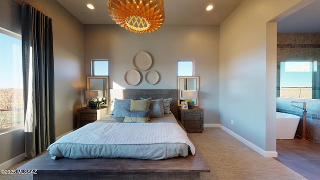 bedroom with recessed lighting, baseboards, and multiple windows