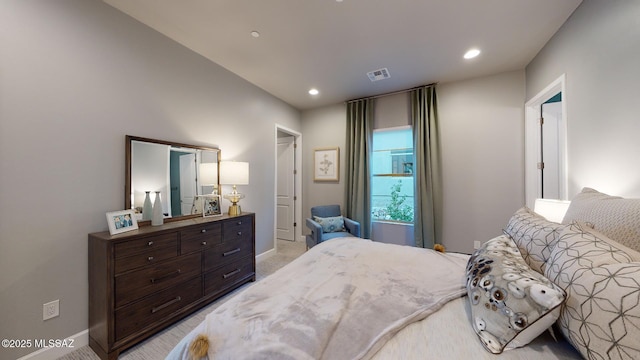 bedroom with baseboards, recessed lighting, visible vents, and light carpet