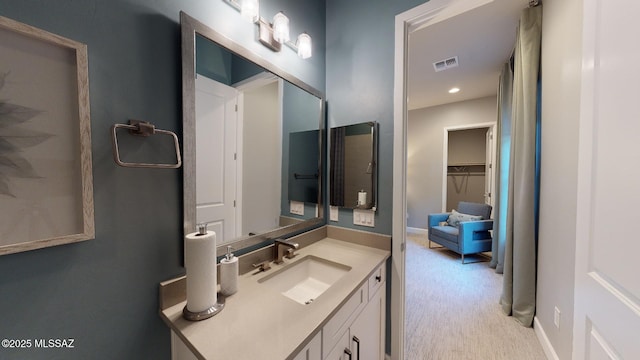 bathroom with visible vents, vanity, and baseboards