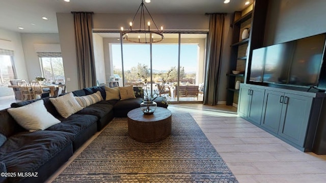 living room with recessed lighting, light wood finished floors, and a chandelier