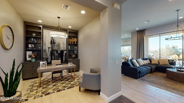 office featuring recessed lighting, visible vents, baseboards, and an inviting chandelier