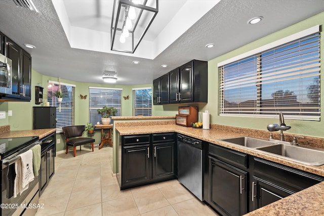 kitchen featuring a sink, range with electric stovetop, a textured ceiling, a peninsula, and dishwasher