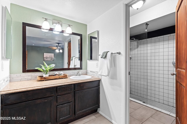 bathroom featuring a shower stall, ceiling fan, decorative backsplash, tile patterned floors, and vanity