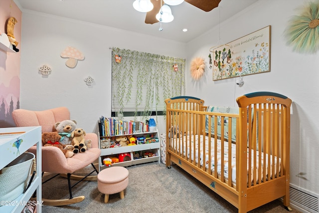 carpeted bedroom with crown molding and ceiling fan