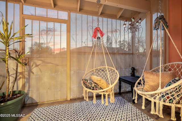 sunroom featuring an inviting chandelier