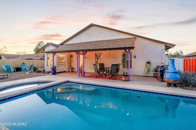 view of pool with a fenced in pool, a patio, an in ground hot tub, and fence