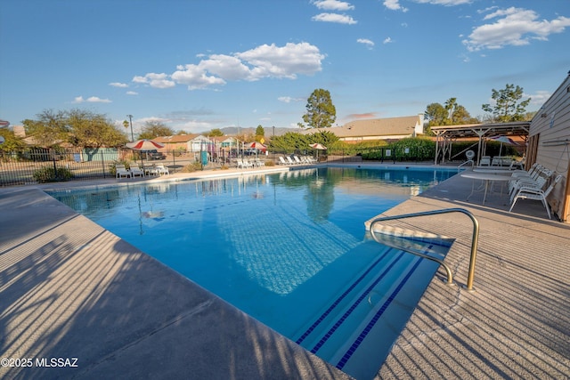 pool featuring a patio area and fence