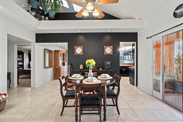 dining room featuring light tile patterned floors, baseboards, ceiling fan, and an accent wall