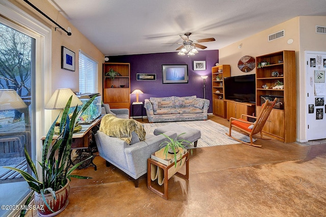 living room with visible vents and a ceiling fan