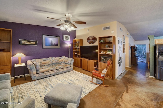 living room with visible vents, a textured ceiling, and a ceiling fan