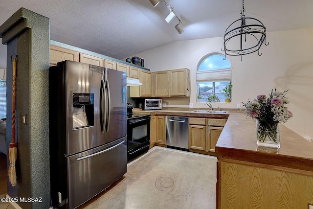 kitchen featuring lofted ceiling, a sink, light brown cabinetry, stainless steel appliances, and under cabinet range hood