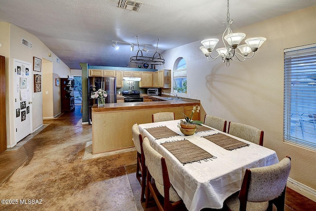 dining space featuring a chandelier, visible vents, a textured ceiling, and baseboards