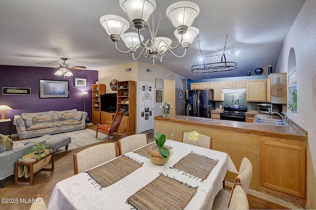 dining room with arched walkways, visible vents, ceiling fan with notable chandelier, and a textured ceiling