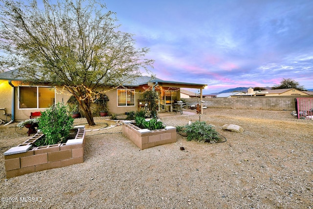 exterior space featuring a patio, a fenced backyard, and stucco siding