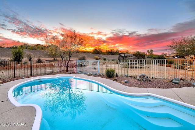 view of swimming pool with a fenced in pool, a trampoline, and fence