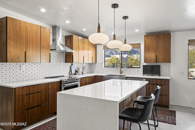 kitchen featuring wall chimney range hood, stainless steel electric stove, a healthy amount of sunlight, and a sink