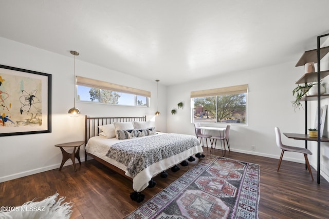 bedroom featuring wood finished floors and baseboards