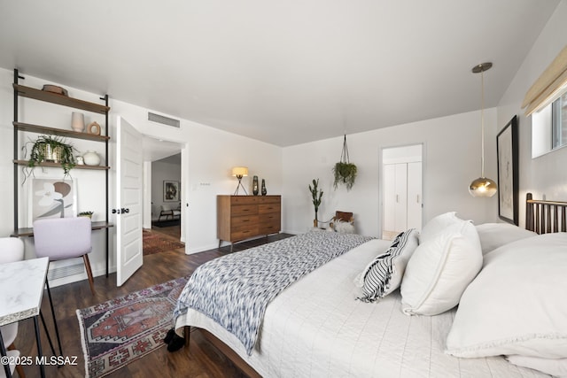 bedroom with wood finished floors and visible vents