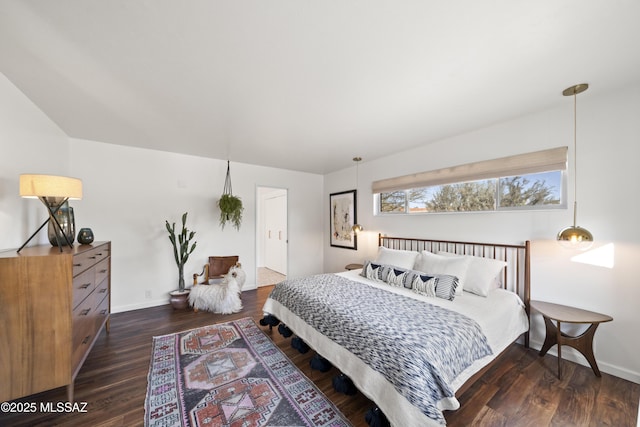 bedroom featuring wood finished floors and baseboards