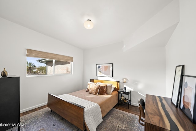 bedroom with wood finished floors and baseboards