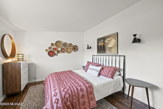 bedroom with baseboards and wood finished floors