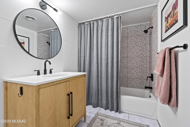 bathroom featuring tile patterned floors, visible vents, tile walls, shower / tub combo, and vanity