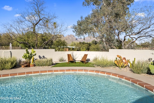 view of pool with fence and a fenced in pool