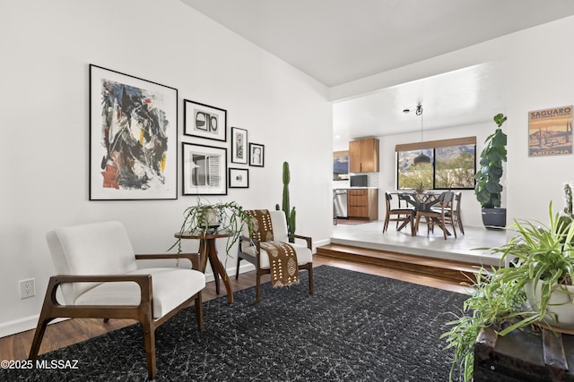 living area featuring baseboards and wood finished floors