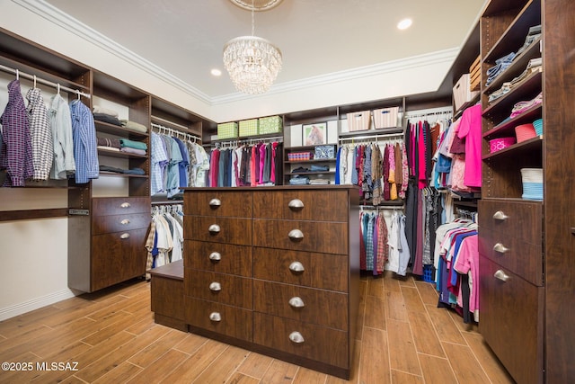 walk in closet featuring a chandelier and wood tiled floor