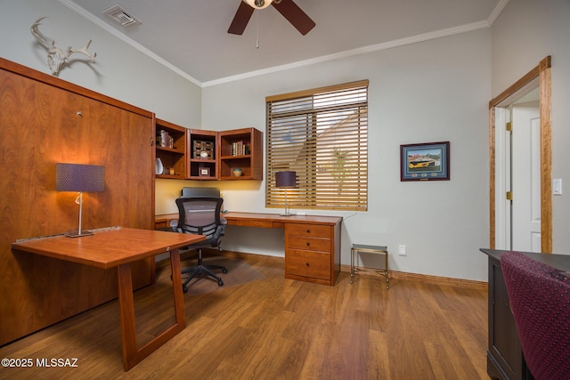 office space with visible vents, baseboards, ornamental molding, wood finished floors, and a ceiling fan