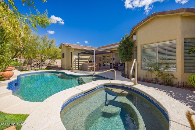 view of swimming pool with a patio, fence, french doors, a fenced in pool, and an in ground hot tub