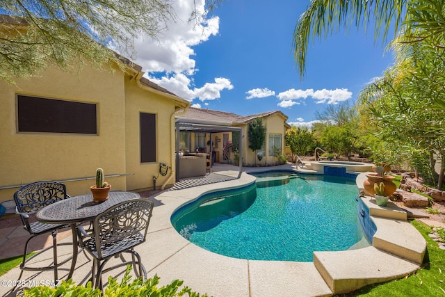 view of pool featuring a patio and a pool with connected hot tub