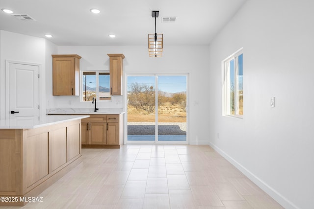 kitchen with visible vents, recessed lighting, light countertops, and baseboards