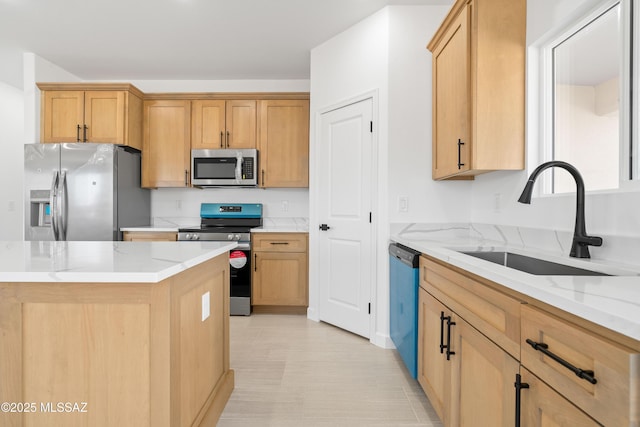 kitchen with appliances with stainless steel finishes, light stone countertops, and a sink