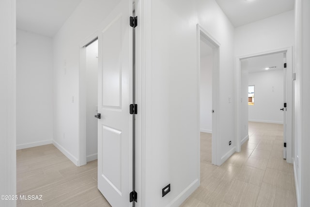 hallway featuring baseboards