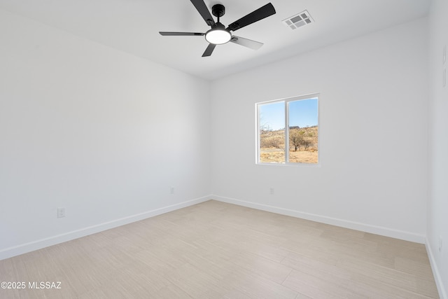 unfurnished room with light wood-style floors, baseboards, visible vents, and ceiling fan