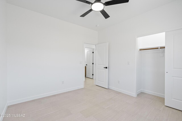 unfurnished bedroom featuring a closet, a ceiling fan, and baseboards