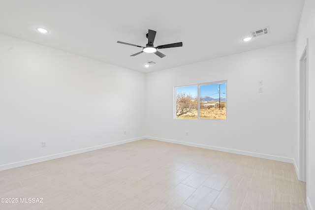 empty room with recessed lighting, visible vents, ceiling fan, and baseboards