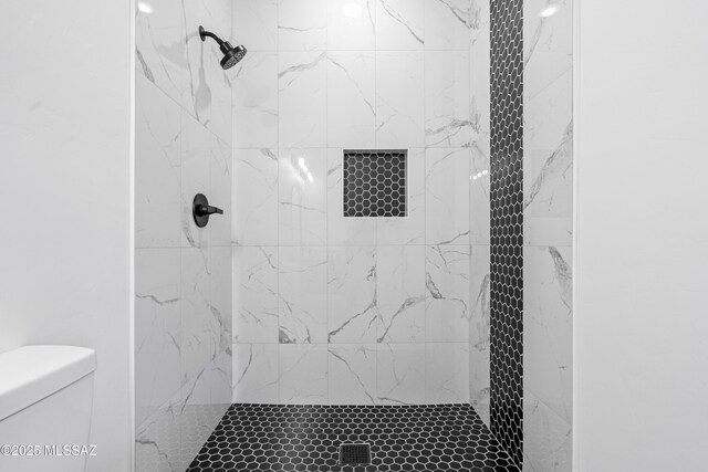 bathroom featuring a shower stall and toilet