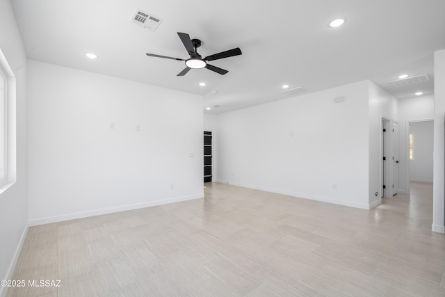 spare room with recessed lighting, visible vents, and baseboards